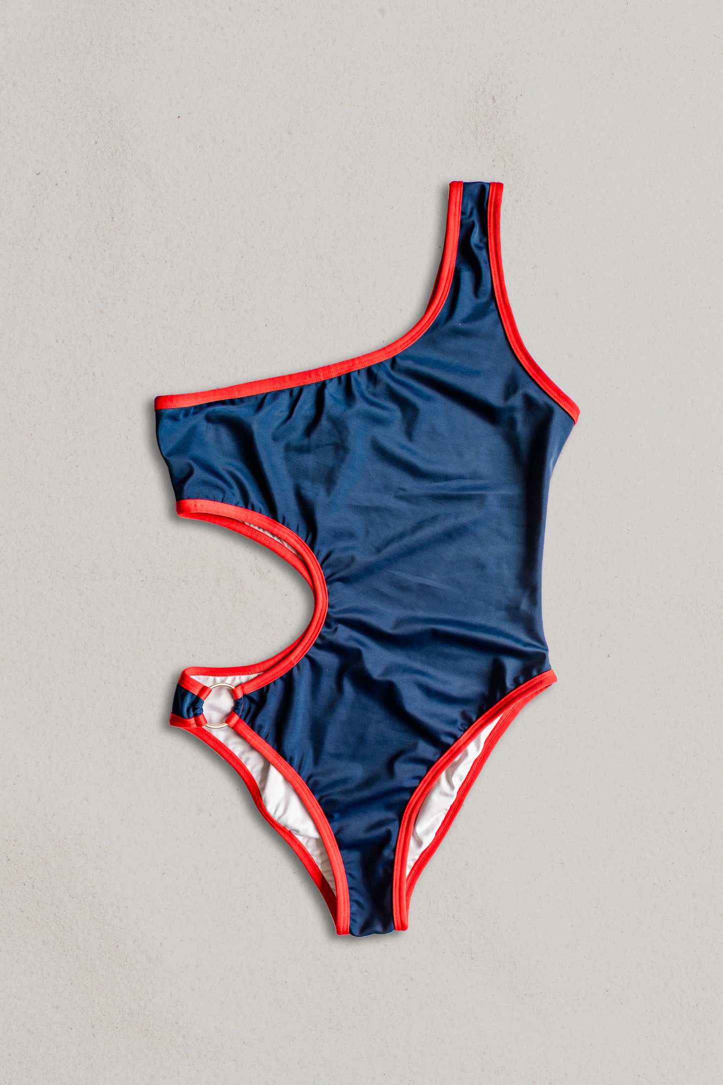 Boomerang one-piece swimsuit in navy with red, front view – Bikini Uni