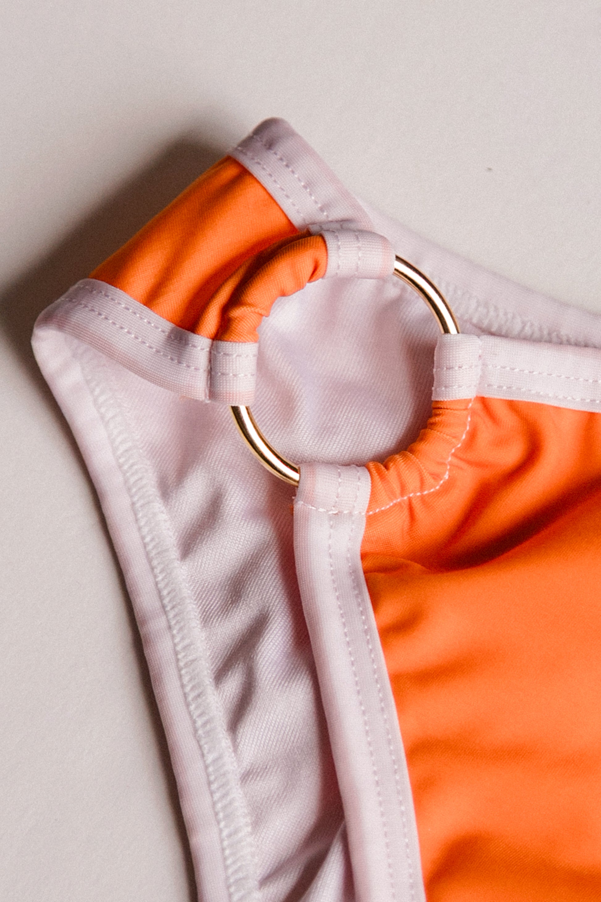 Boomerang one-piece swimsuit in orange with white, front detail – Bikini Uni