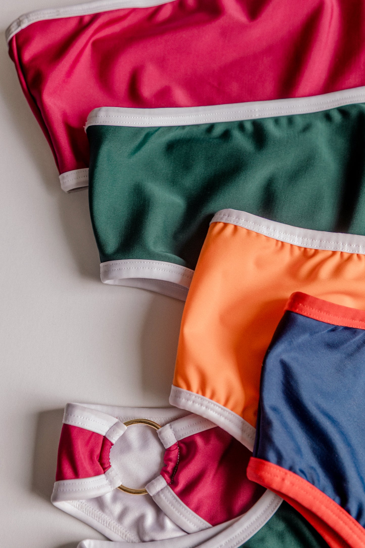 Boomerang one-piece swimsuit, stacked color variants close-up – Bikini Uni