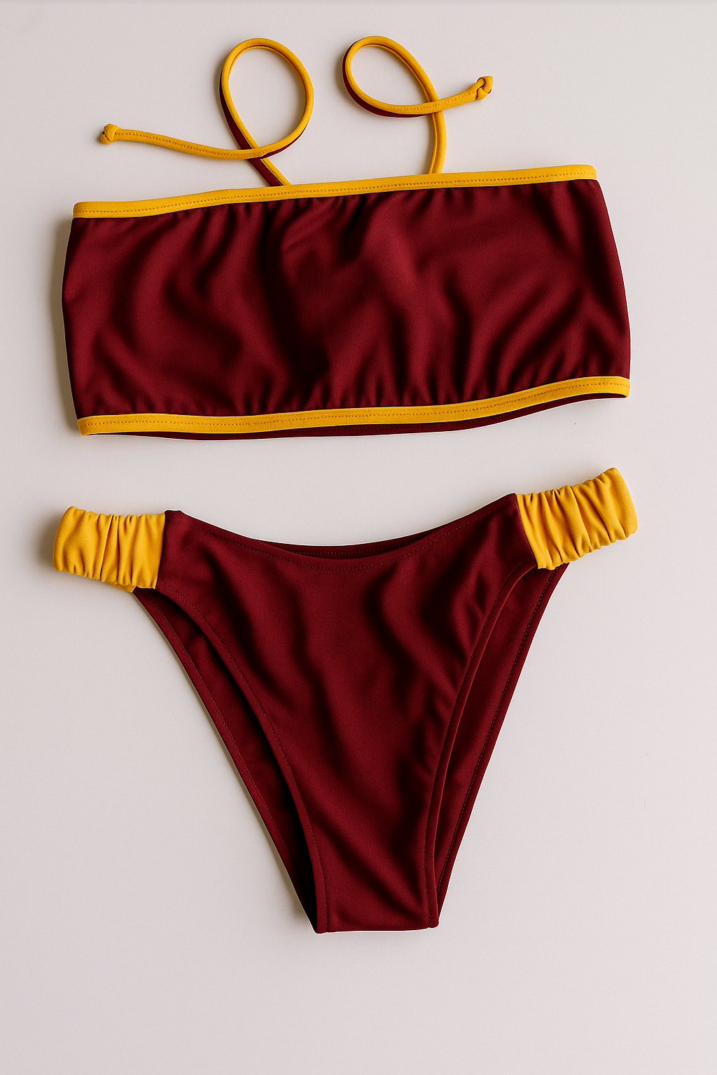 Dos Tierras two-piece bikini in maroon with gold, front flatlay view – Bikini Uni