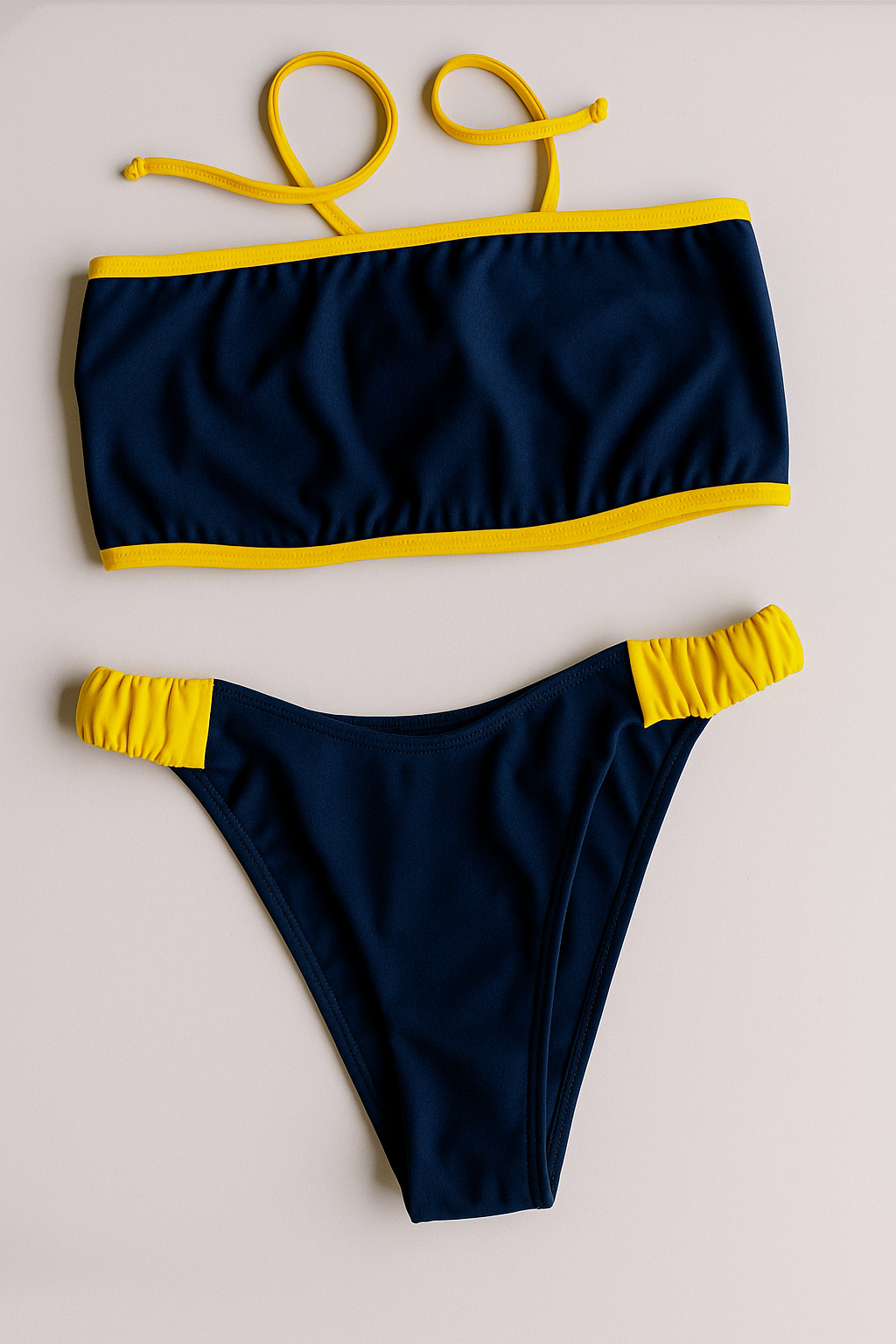Dos Tierras two-piece bikini in navy with gold, front flatlay view – Bikini Uni