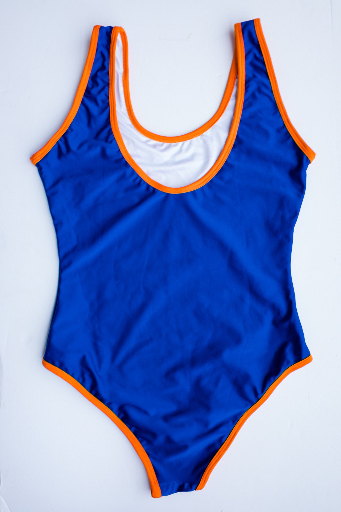 La Tradicional bikini in blue with orange trim, front flatlay view – Bikini Uni