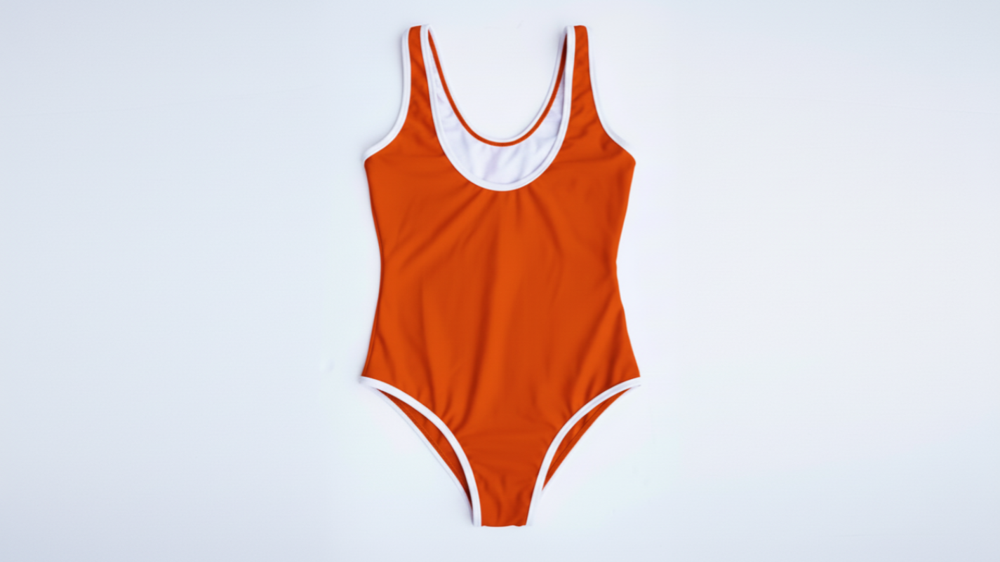 La Tradicional bikini in orange with white trim, front flatlay view – Bikini Uni